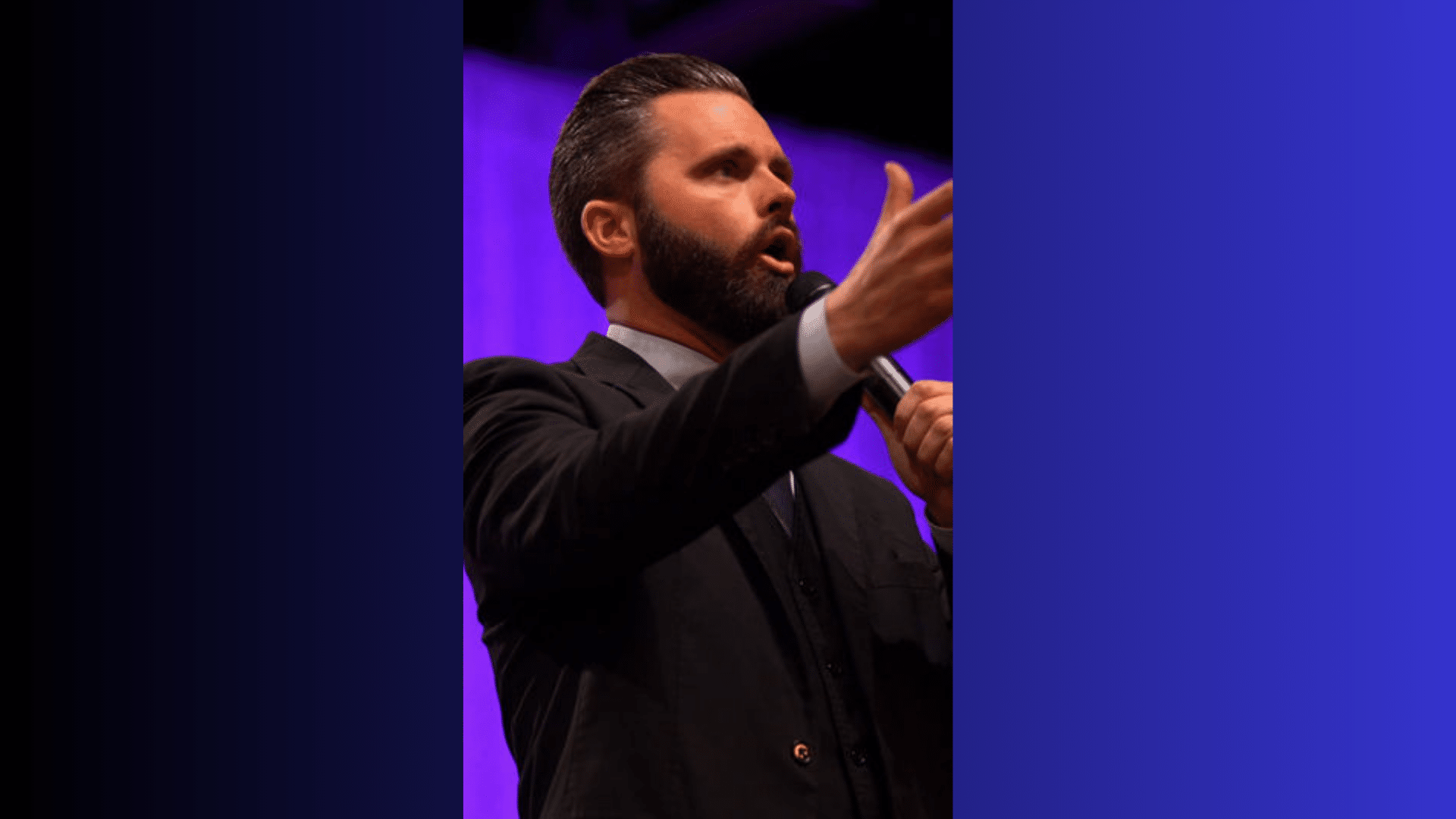Tyler Gaulden speaking on stage with a microphone during a church sermon under purple lighting