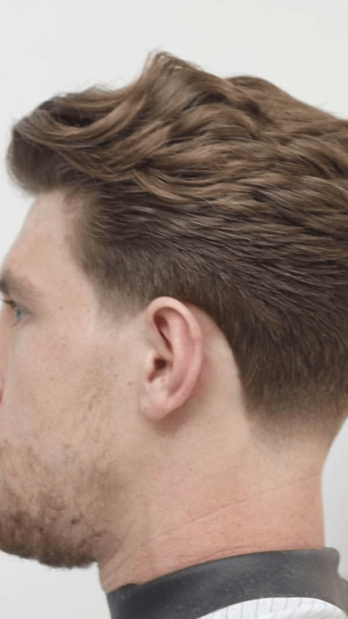 low fade back brushed hairstyle