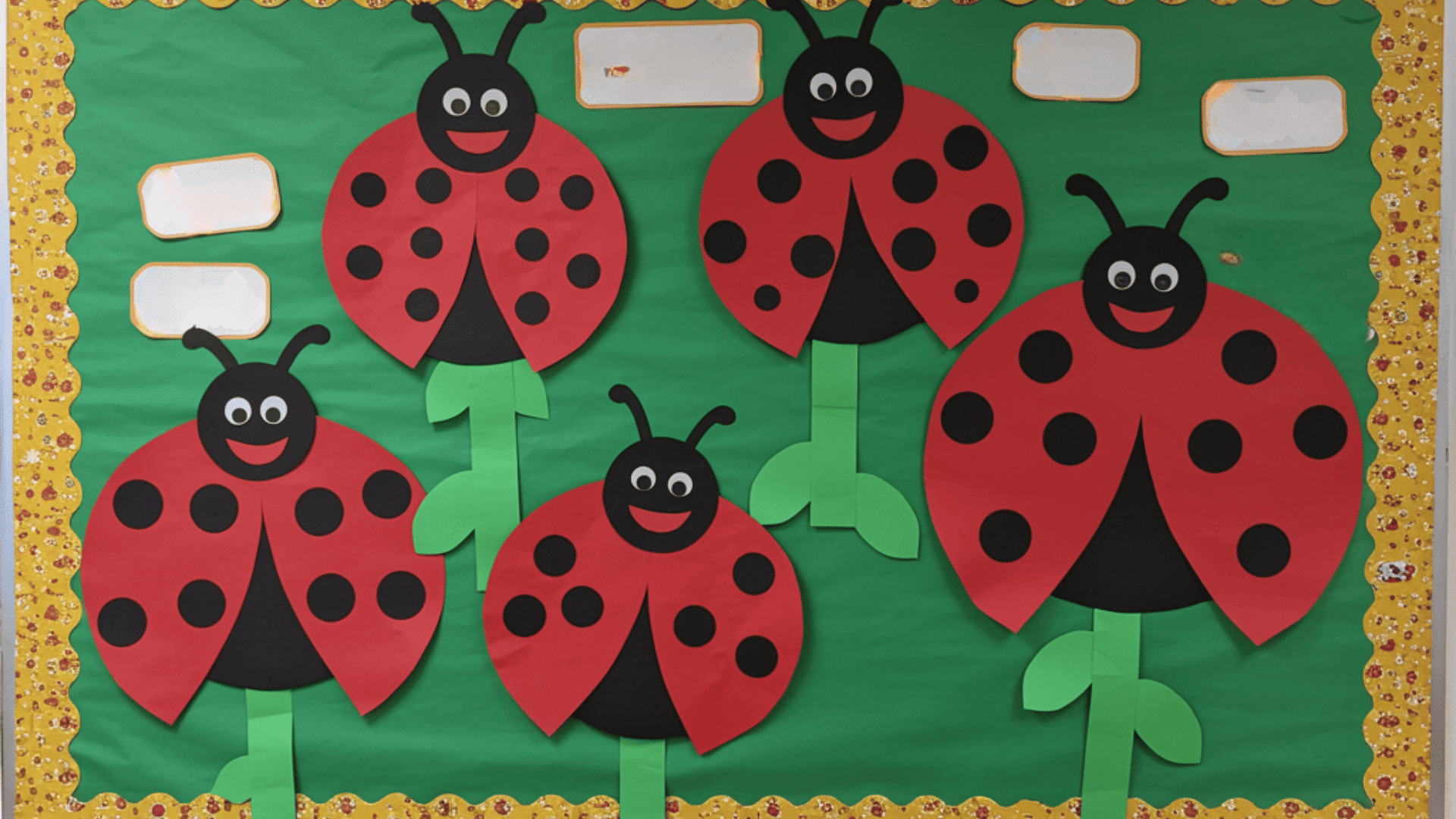 love bug garden bulletin board with paper ladybugs hearts and green stems