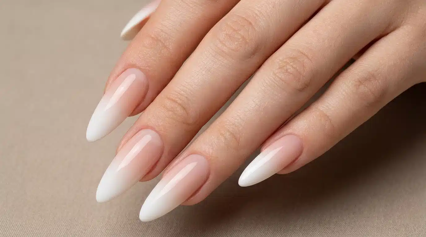 A close-up of a woman's hand showcasing long white acrylic nails