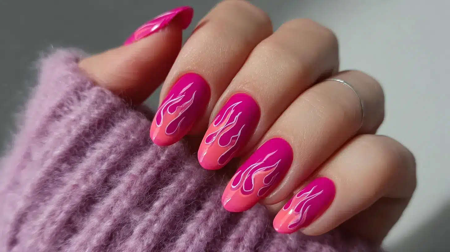 Hot pink flame nail art with soft ombre base and white outlined flames creates a bold, edgy manicure perfect for statement looks