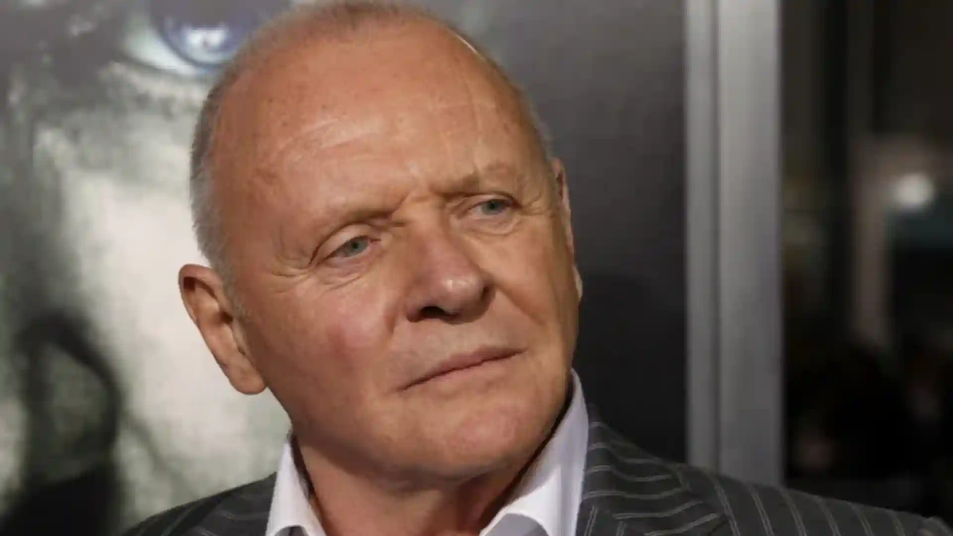 Close-up portrait of actor Anthony Hopkins wearing a pinstripe suit and white shirt.