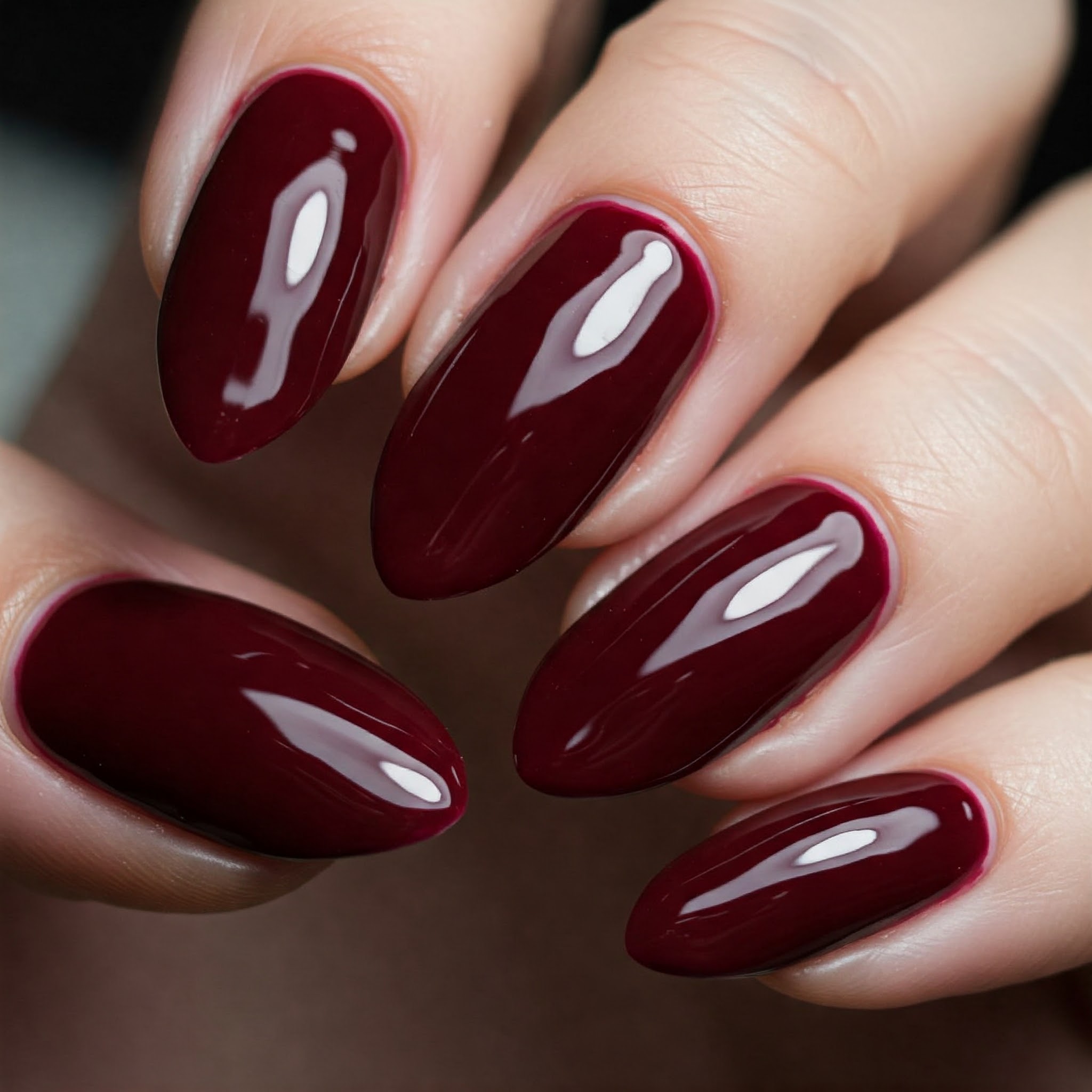 Classic burgundy grace autumn nails on fair tone skin.