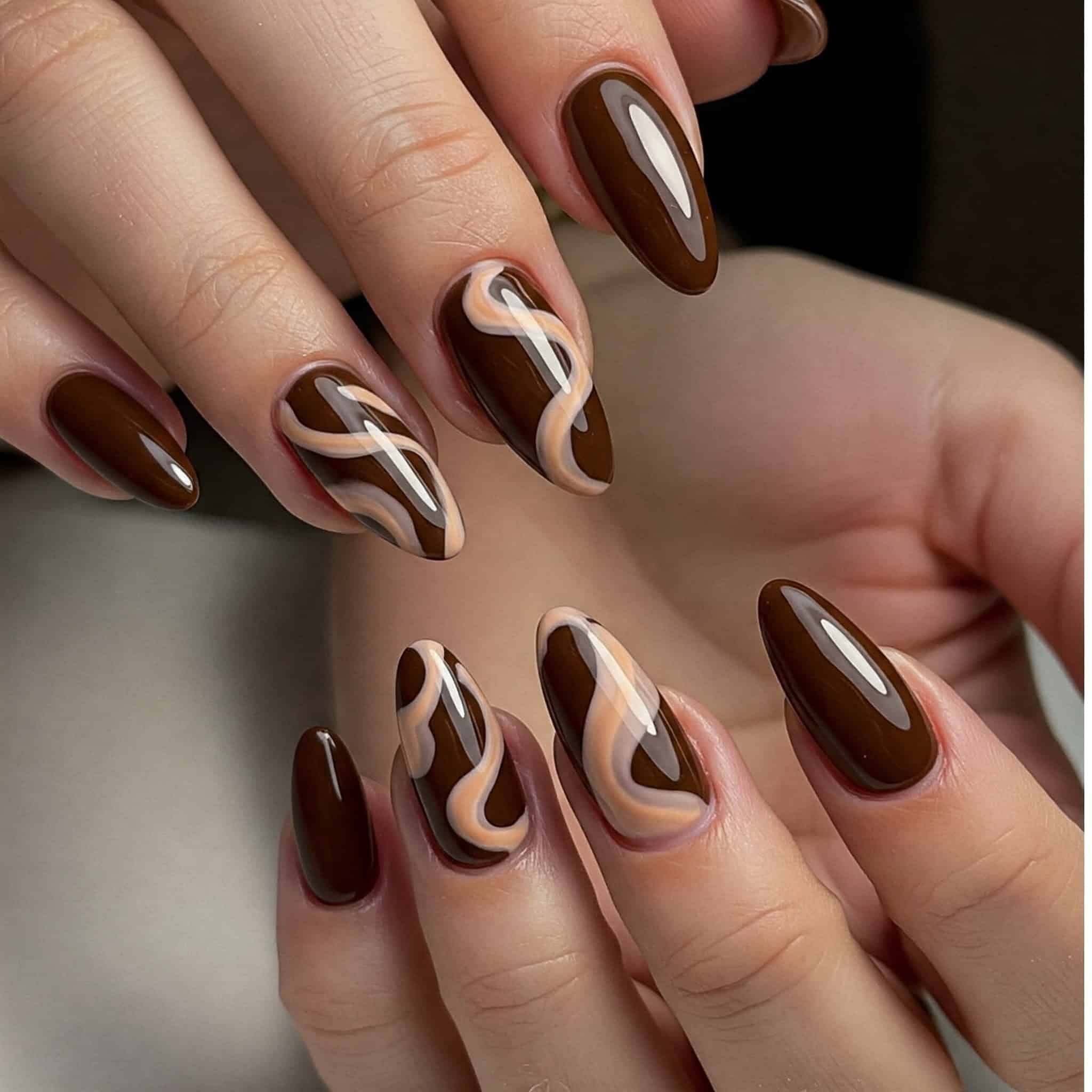Beautifully designed nails with chocolate and brown motifs, reflecting a sophisticated and trendy nail art aesthetic