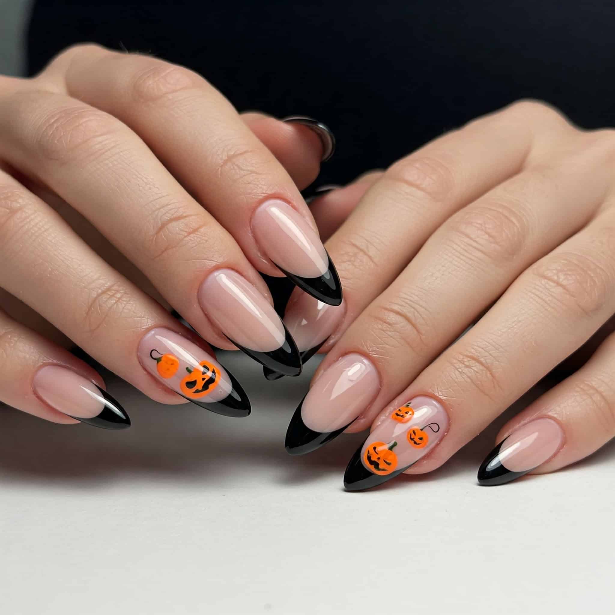 A collection of creative Halloween nail art designs featuring pumpkins, ghosts, and spider webs on various nail shapes.