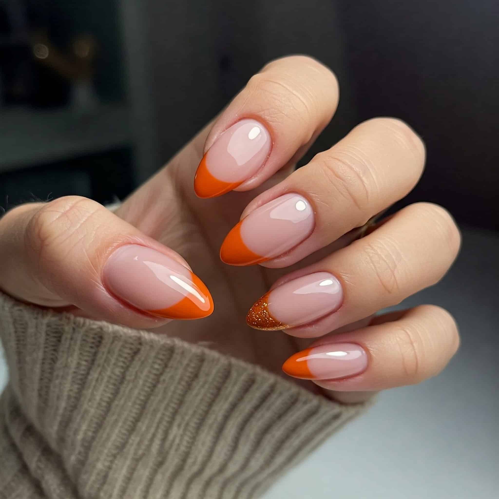 A autumn classic pumpkin spice french tips with orange and glitter tips