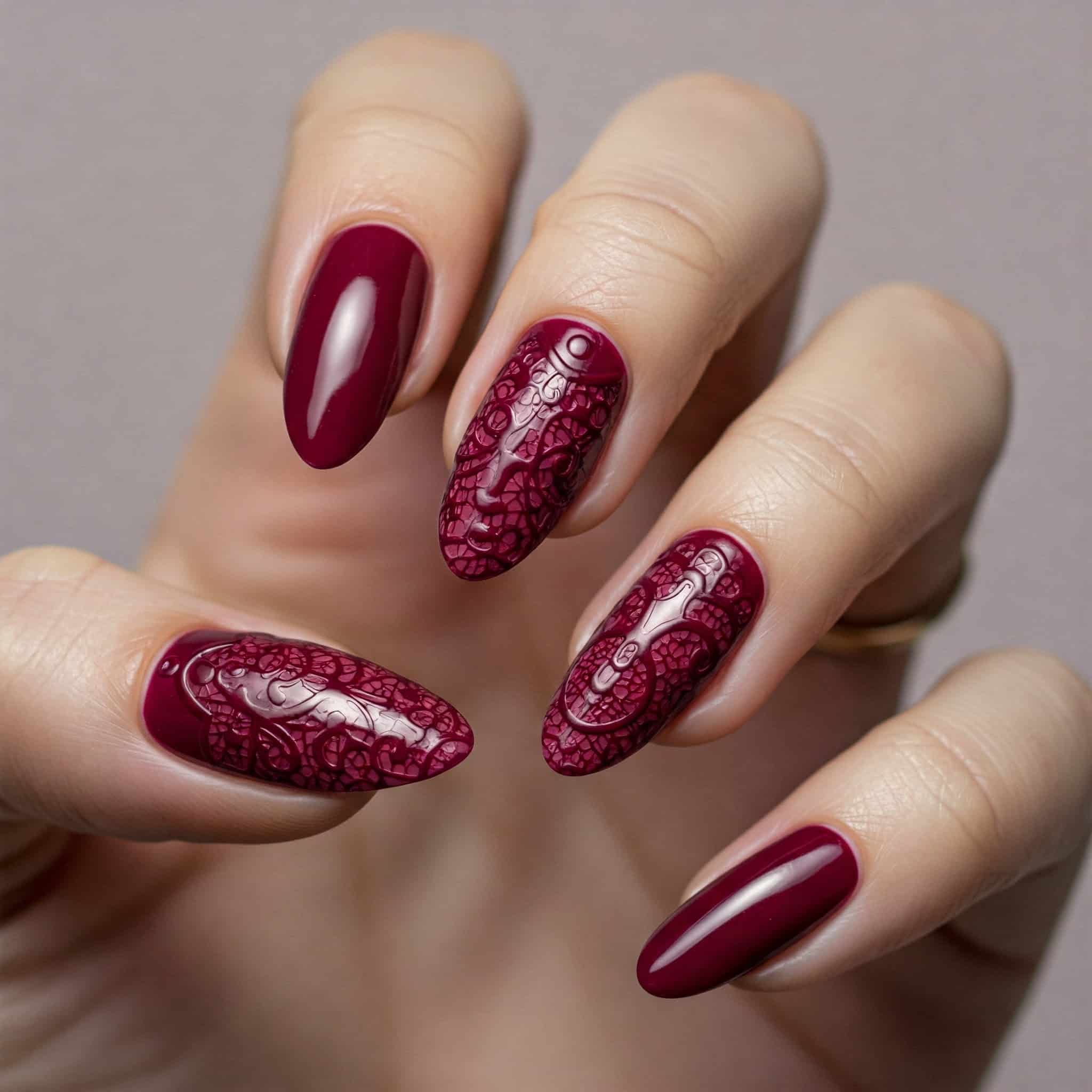 A close-up of a woman's hand with burgundy nails and a glossy red nail polish