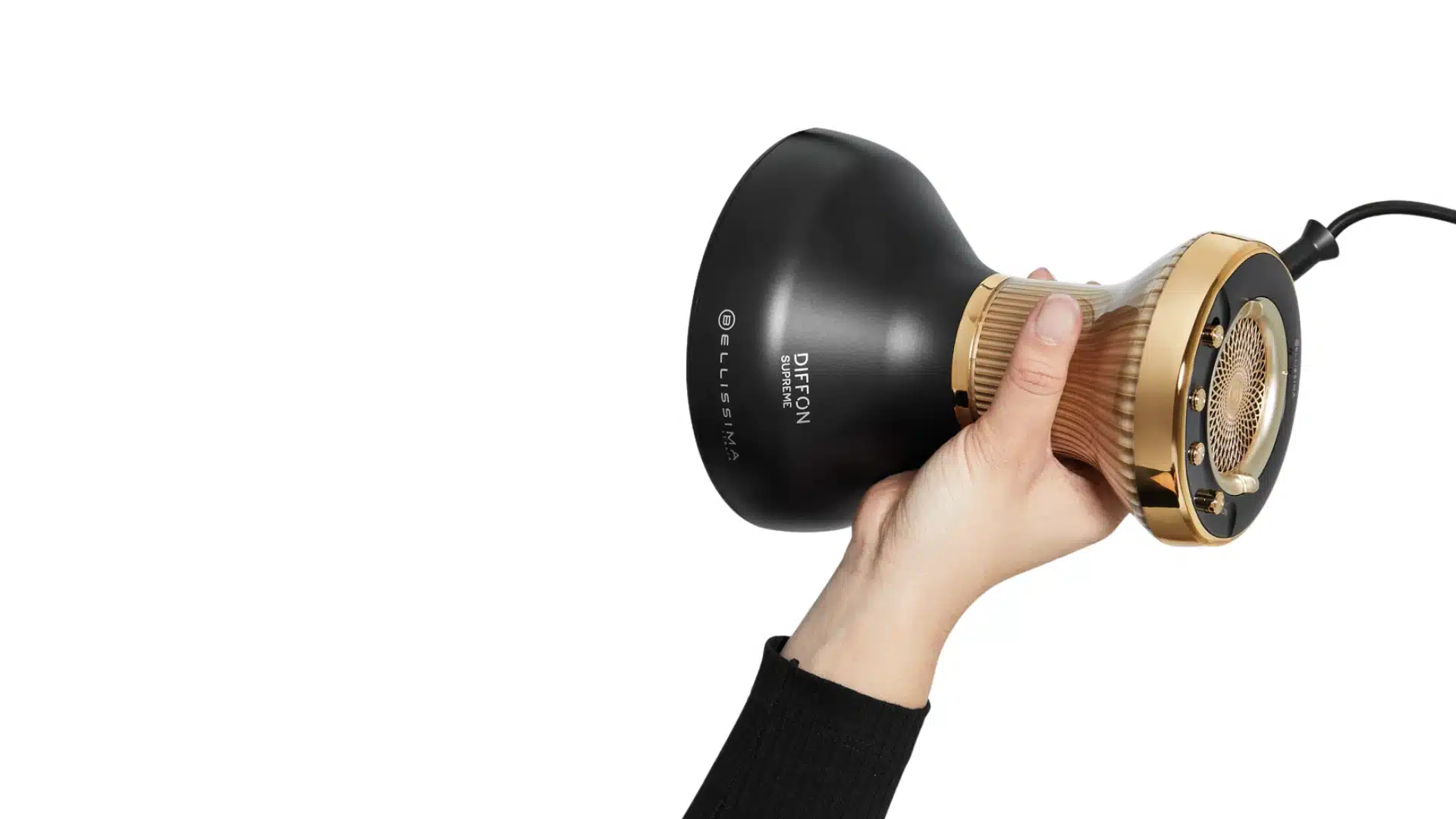 Hand holding a black and gold Bellissima diffuser hair dryer on a white background.