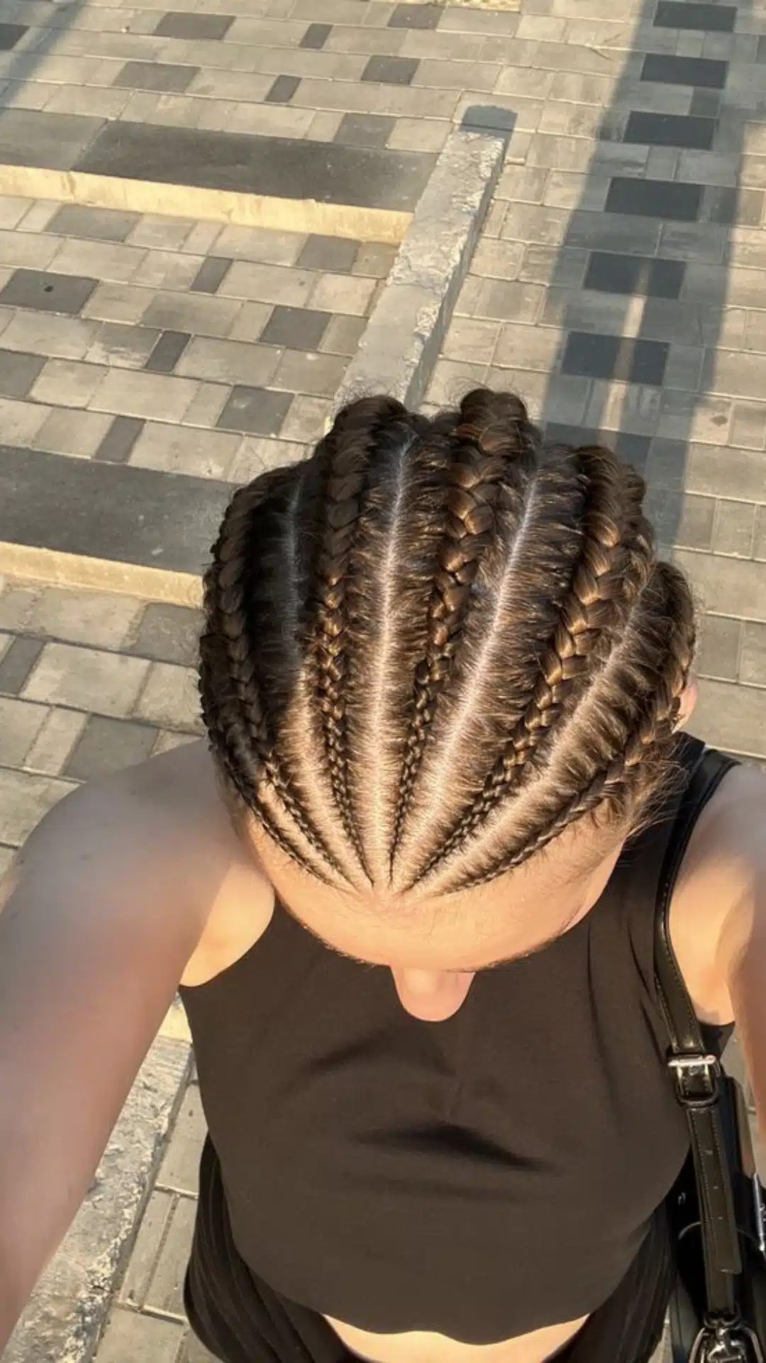 Cornrow braids styled straight back with visible scalp parts