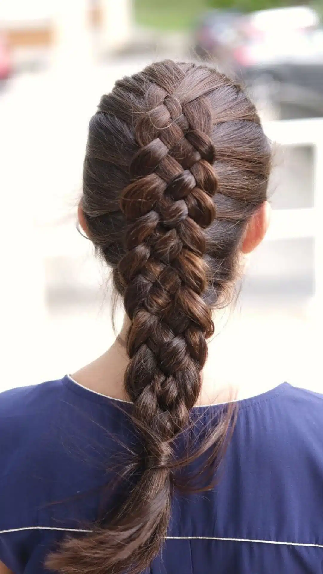 Four strand braid styled into a long ponytail