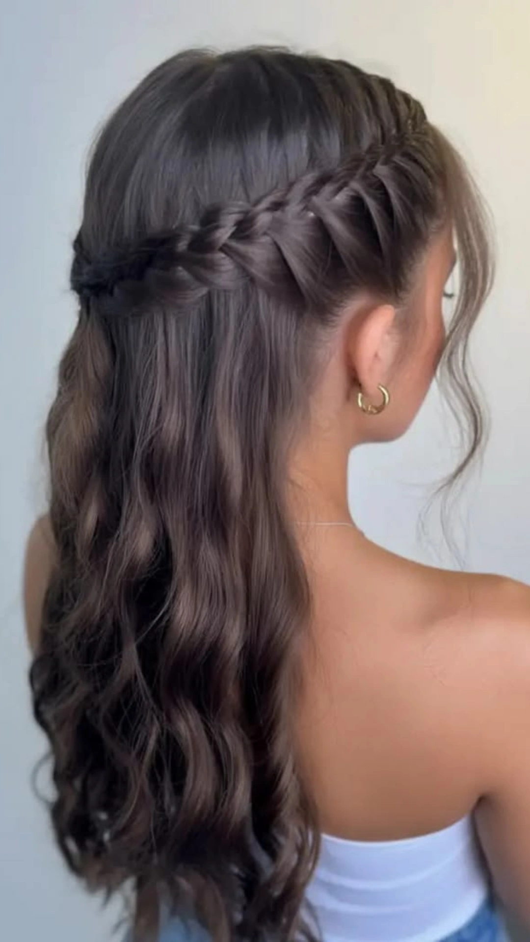 Half up braided style with the rest of the hair left in loose waves