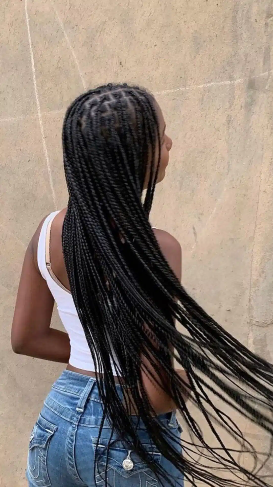 Knotless braids styled long and straight down the back