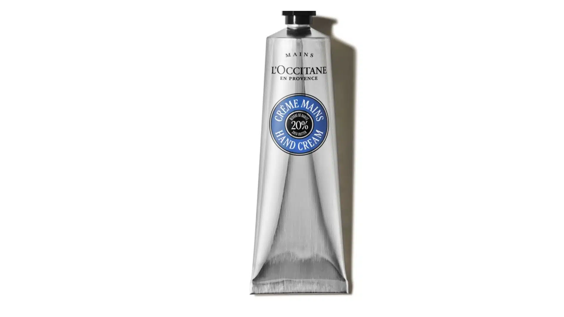L'Occitane Shea Butter Hand Cream in a silver tube with blue label and black cap on a white background.