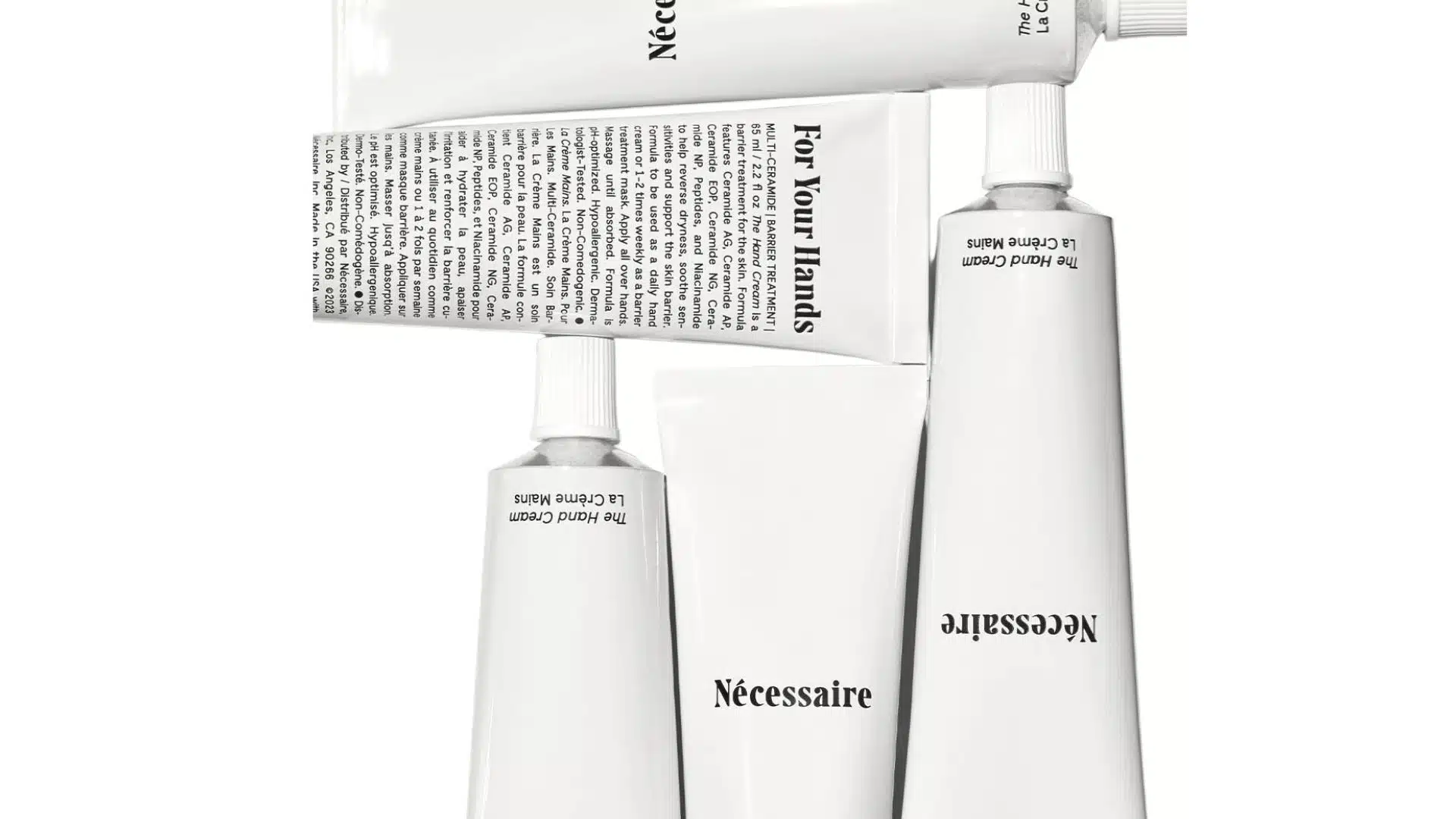 Nécessaire The Hand Cream in minimalist white tubes arranged on a white background.