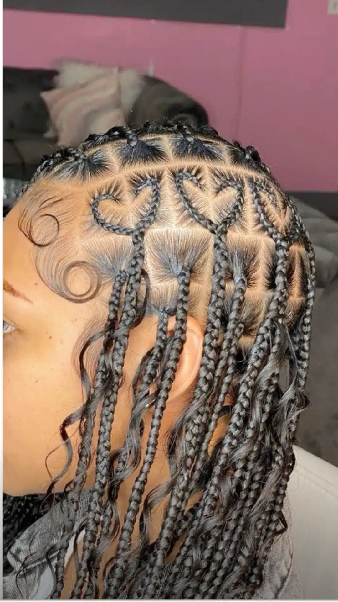 black girl with heart part boho braids featuring neat scalp design loose curls and stylish protective hairstyle