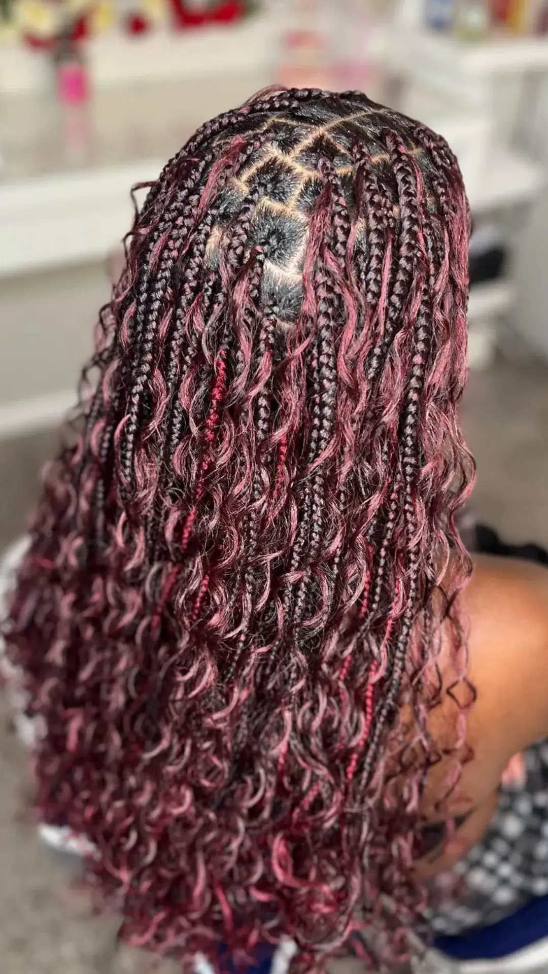 black girl with burgundy boho braids featuring wine red highlights loose curls and long protective braid hairstyle