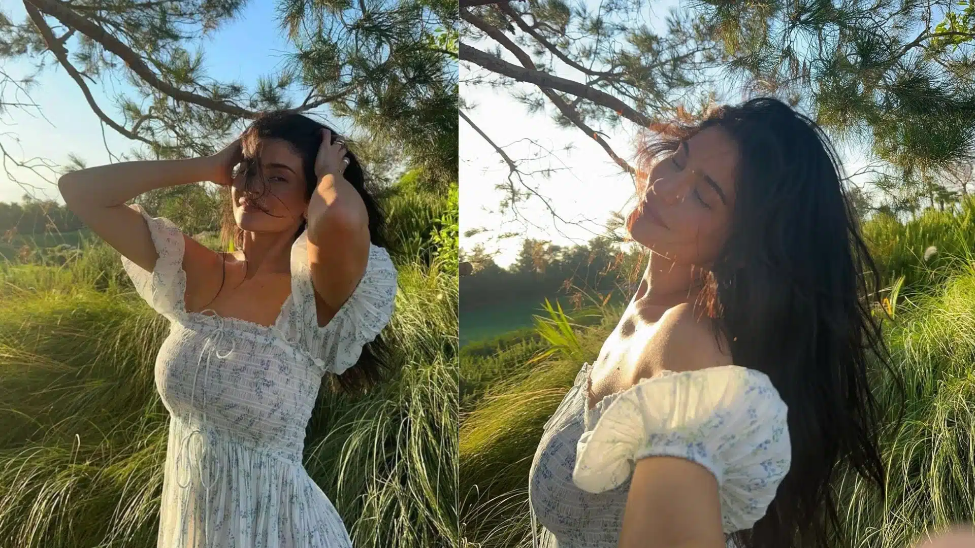 Kylie Jenner in a flowing white dress stands against a backdrop of a vibrant green tree