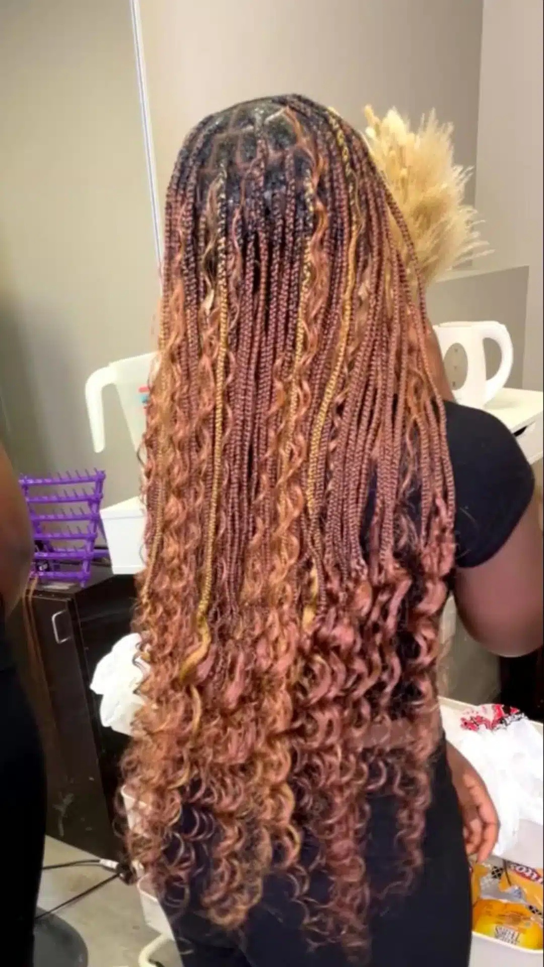 black girl with long boho braids featuring defined curly ends warm brown tones and neat protective braid style