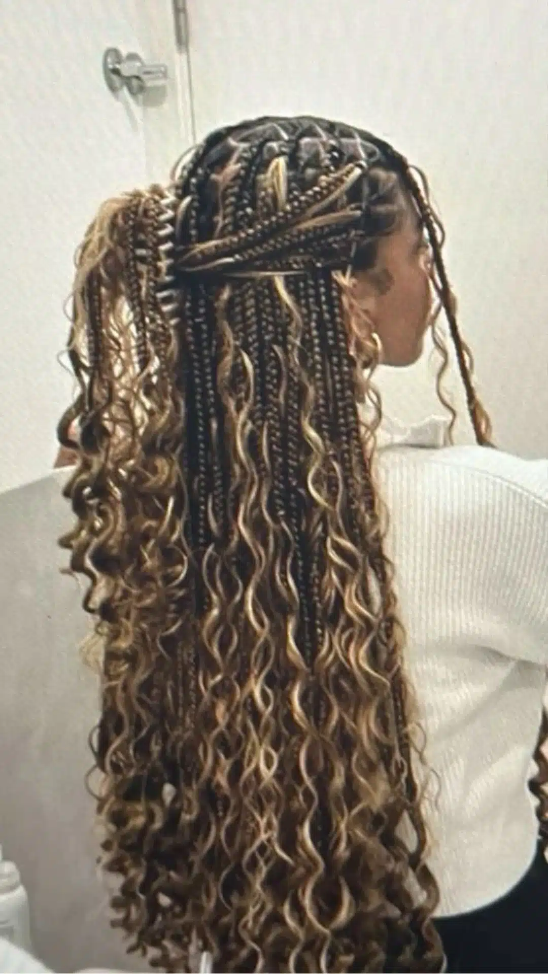 black girl with half up half down boho braids featuring long loose curls and highlighted protective braid style