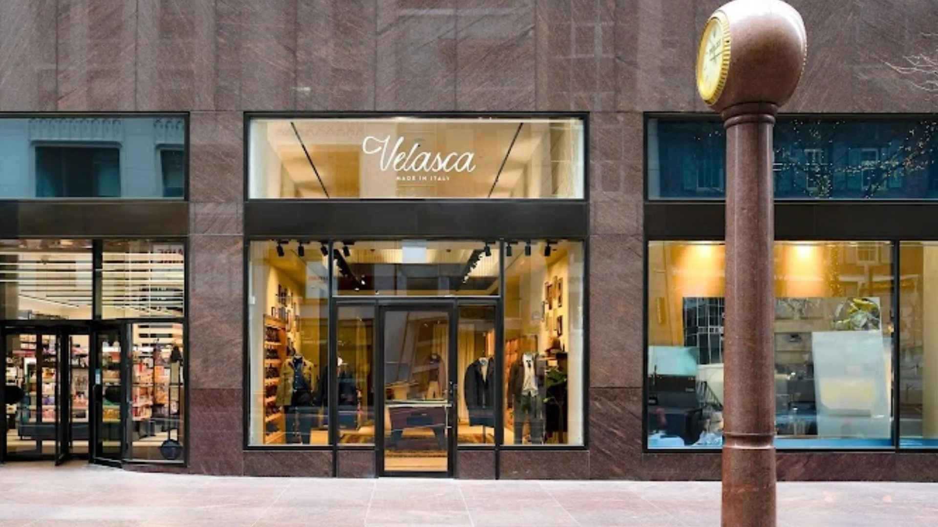 A store facade features a large central glass window with the