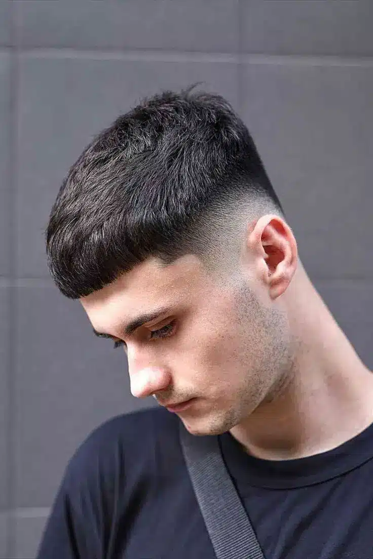 Caesar cut hairstyle with a short horizontal fringe and high skin fade around the sides