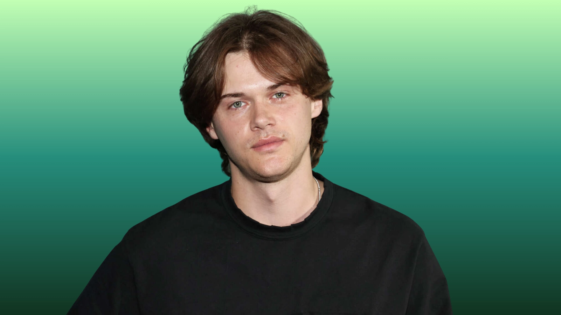 Christopher briney wearing a black shirt stands against a vibrant green background