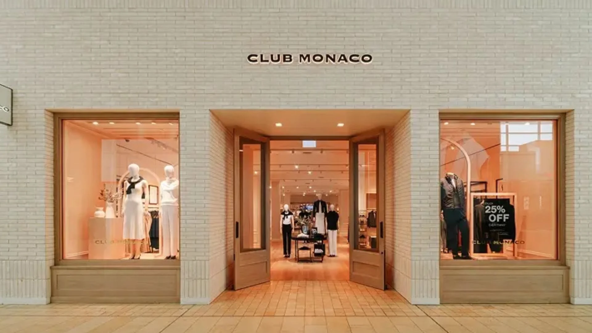 Exterior view of Club Monaco's new store in New York City, showcasing modern architecture and inviting entrance