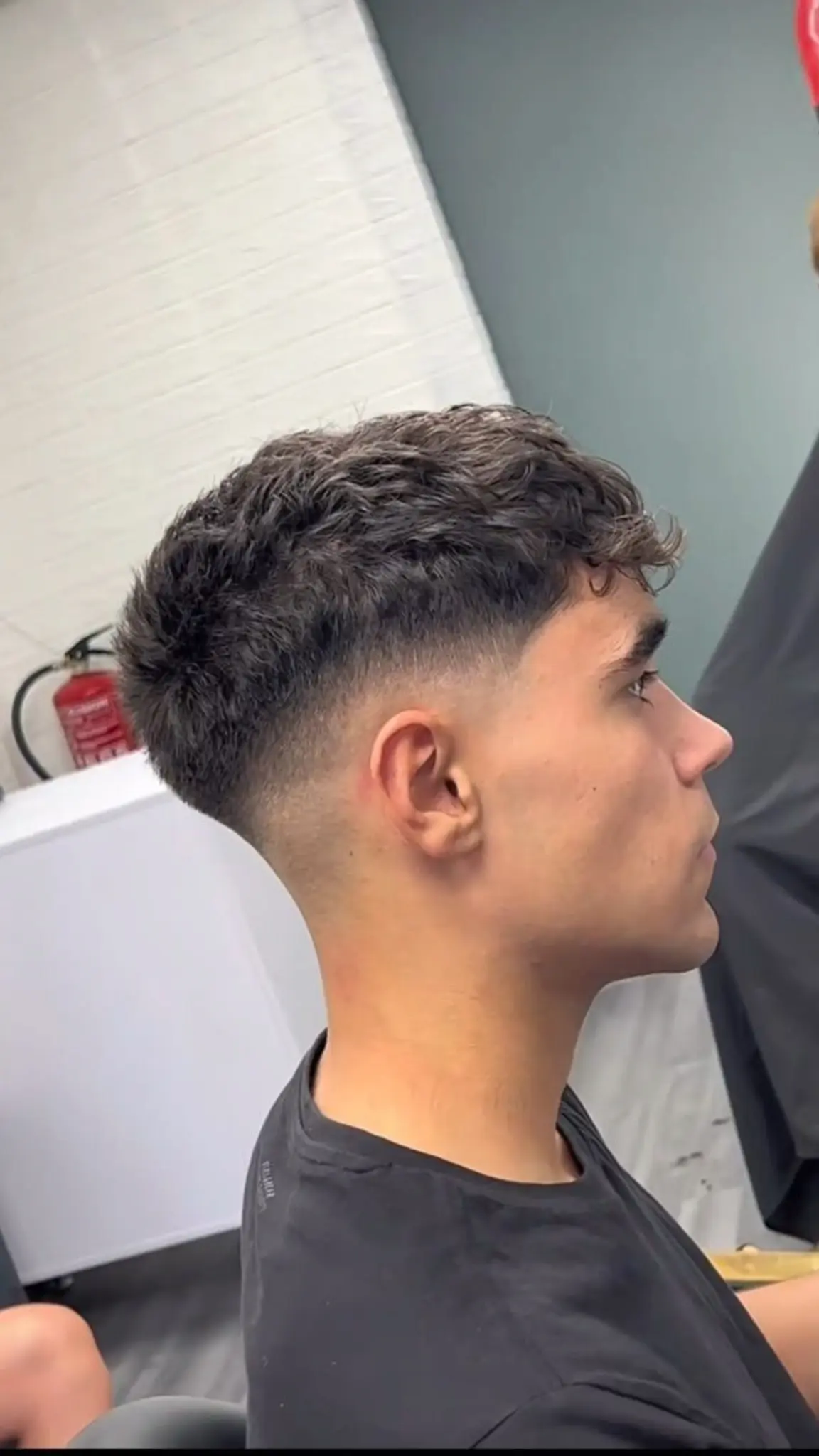 French crop haircut with a blunt fringe textured top and low skin fade on the sides
