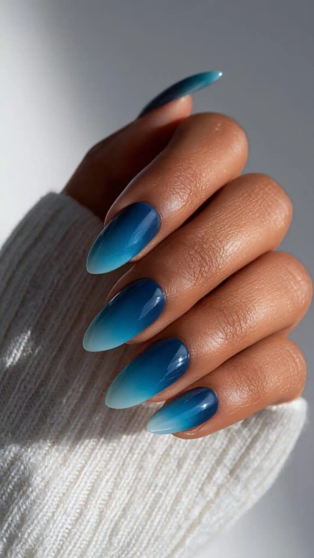 Icy blue to navy ombre nails on almond tips