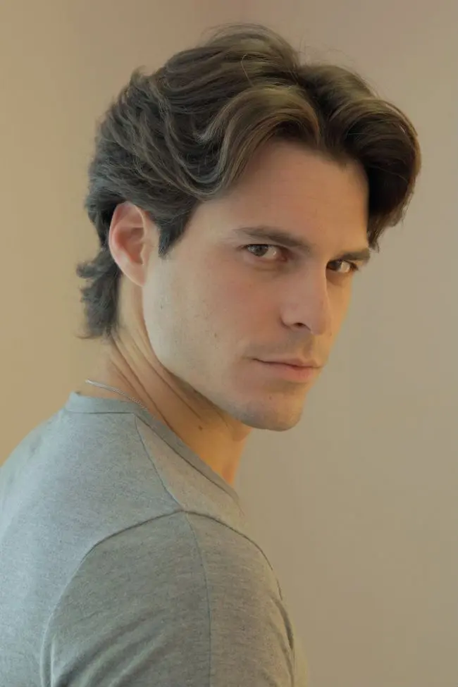 Middle part hairstyle with layered medium length hair and naturally parted curtain bangs