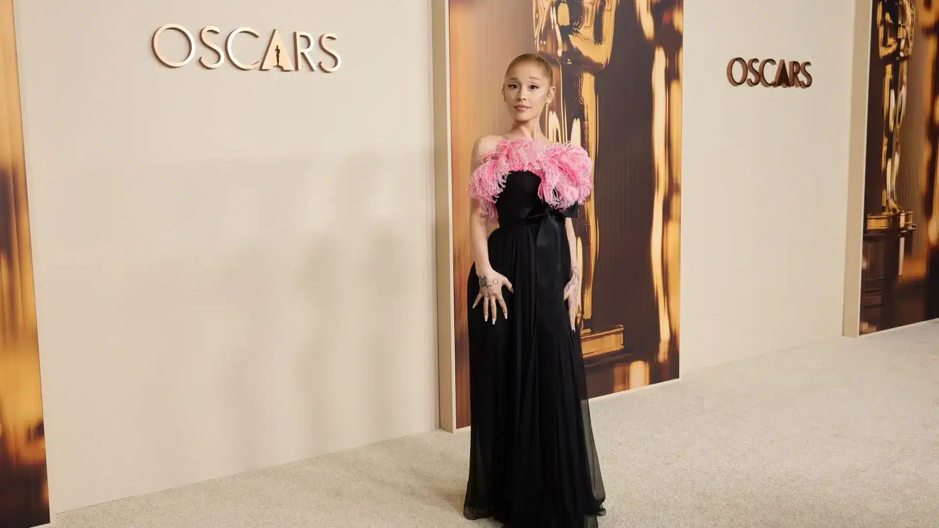 Before the 2025 Oscars, Ariana Grande took part in the Academy Awards Nominees Dinner. She dressed up in an old Yves Saint Laurent dress from 1991. It was a black dress that had a corset top with bow decorations along with a chiffon skirt. The hemline of the dress was adorned with pink ostrich feathers which referred to Ariana's Glinda character. The same dress was previously worn by Catherine Deneuve at the 1993 Oscars. Ariana wore simple pearl studs rather than fancy jewelry.