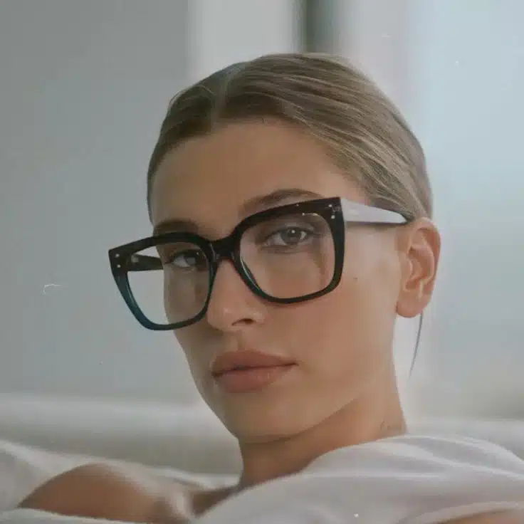 Hailey Bieber wearing oversized square glasses, showcasing a relaxed and stylish look.