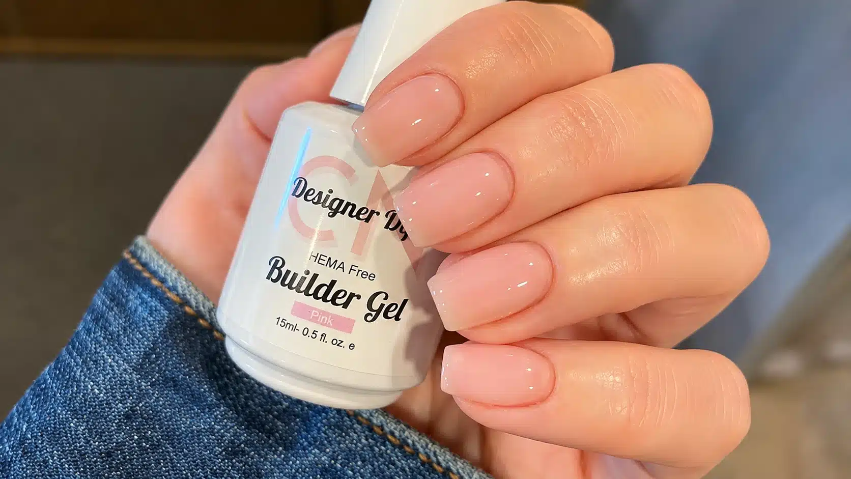 pink builder gel manicure on natural nails with a glossy finish and smooth, structured shape
