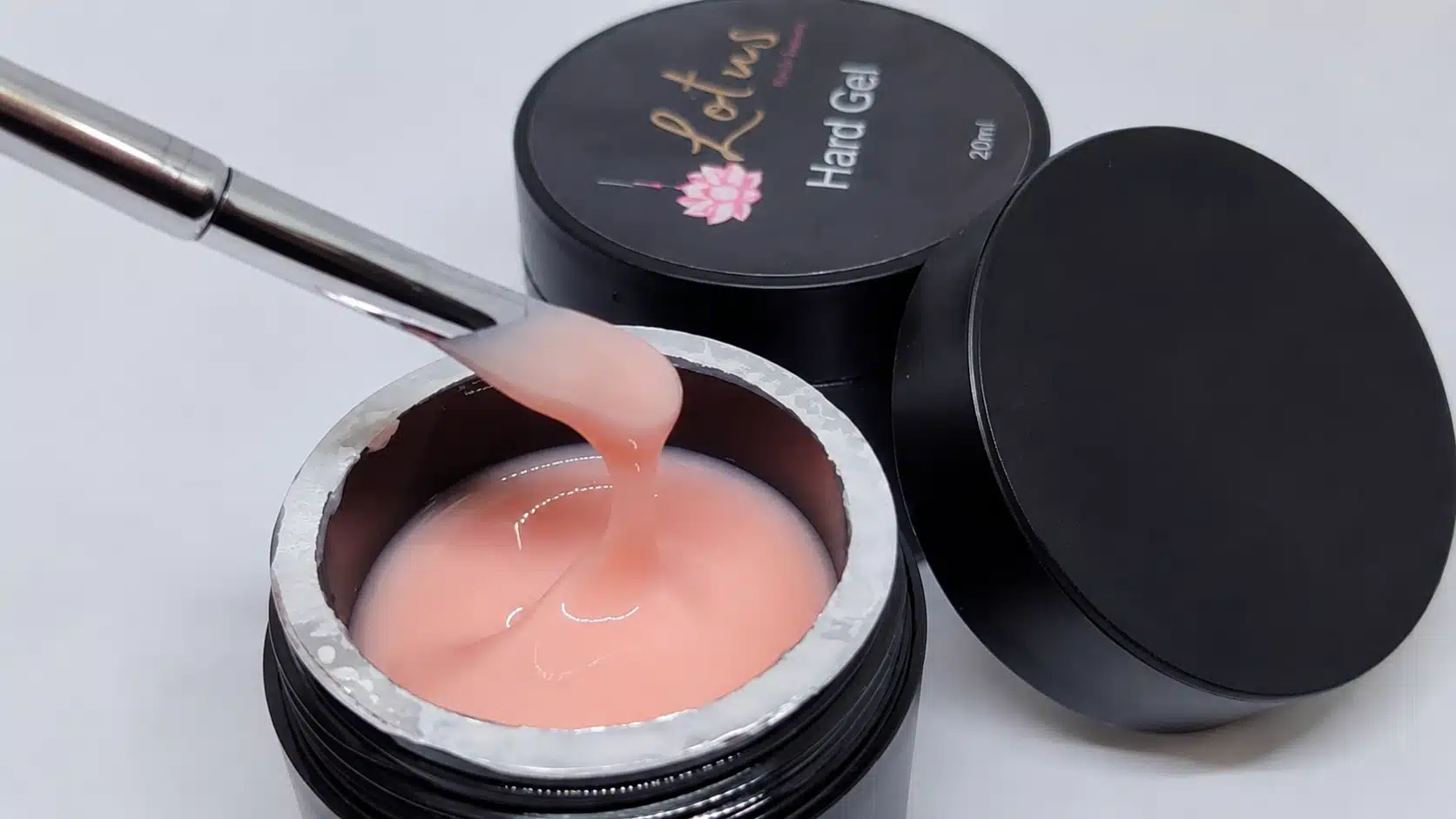 pink hard gel in an open nail gel pot, showing its thick consistency and soft pink color